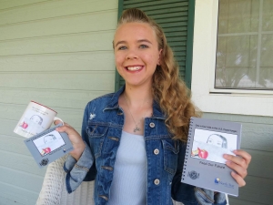 Rebecca Shaver poses with some of the items for sale at Catholic Charities and northstaryouth.org.